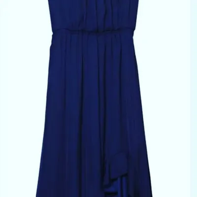 A simple tip for a more flattering silhouette. A dress with draping or ruching, like this blue one, is an excellent choice to create a smooth line around the stomach area, helping you feel more comfortable and confident.