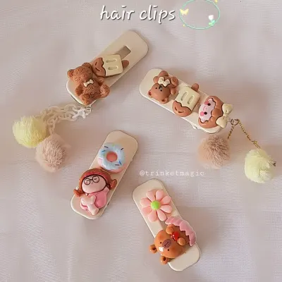 A collection of my cutest handmade hair clips, featuring teddy bears, donuts, and flowers. They are perfect for birthday return gifts, Rakhi favors, or back-to-school style.