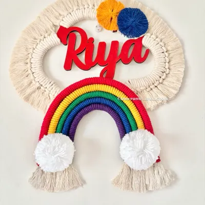A bright and cheerful rainbow name hanging for Riya. The classic rainbow colors, fluffy pom-pom clouds, and bold red name make this a perfect piece of decor for a child's room.