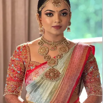 Our beautiful bride Anusha, looking absolutely regal on her wedding day. The heavily embroidered blouse was custom-designed to match her stunning saree and traditional jewellery.