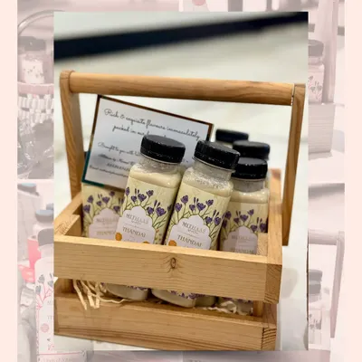 My artisanal Thandai, presented in a rustic wooden basket. Each bottle is blended with handpicked almonds and rich dry fruits, crafted just the way tradition intended.
