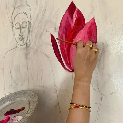 The first step is always bringing the vision to life directly on the wall. Here you can see the detailed pencil sketch of the Buddha and lotuses, establishing the foundation for the entire mural.
