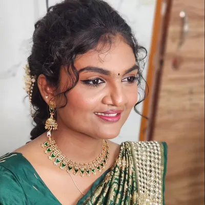 A beautiful smile from a happy client. This look features soft curls and a natural makeup style that enhances her features.
