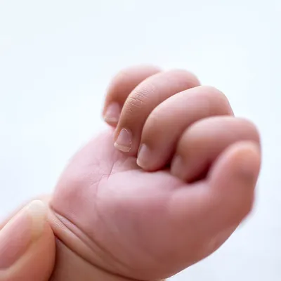 A tiny hand, perfectly formed, grasping a parent's finger. These are the details you'll want to hold onto forever.