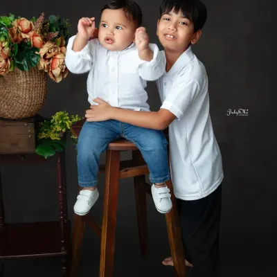 Only a brother can bring out a smile like this. Capturing the fun and playful bond between siblings is always a joy.