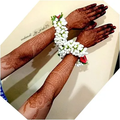The stunning result of my organic henna paste after 48 hours. The deep, dark stain looks beautiful against the skin and is complemented by traditional floral bracelets (gajra).