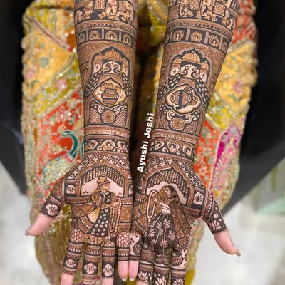 A classic bridal mehendi featuring the Varmala ceremony on the palms. The arms are adorned with royal elephants, peacocks, and auspicious symbols like the dhol, shehnai, and kalash.