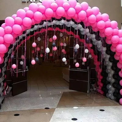 A grand balloon arch I built to create an impressive entrance tunnel for an event. The layered design uses pink, black, and white balloons to guide guests into the party space with style.