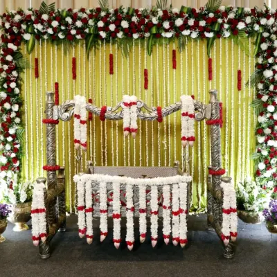 A classic and elegant naming ceremony setup. I used strings of fresh tuberose (malli poo) and a floral border of red and white roses to create a beautiful backdrop for the decorated thottilu (cradle).