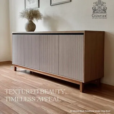 A timeless sideboard cabinet featuring a light-colored fluted veneer. This piece combines minimalist design with textured beauty, making it a functional work of art.