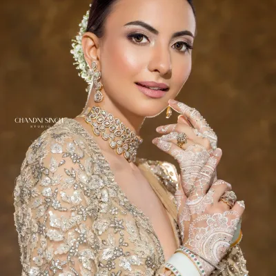 This is the modern minimalistic bride. The look is created with airbrush makeup for a flawless, lightweight finish that lasts all day. Paired with delicate white henna, it's a perfect blend of contemporary style and tradition.