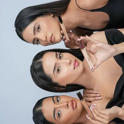 A creative group shot for a concealer campaign, with three models showcasing the product for different skin tones.