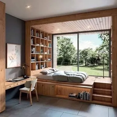 A stunning bedroom concept featuring a raised platform bed set against a large window. The integrated bookshelves and desk create a perfect space for reading and relaxation.
