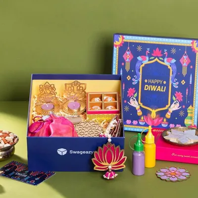 A festive hamper shoot for Swageasy, capturing a colorful Diwali gift box. The flat lay composition is carefully arranged to display all the contents, from sweets and nuts to decor items, making it ideal for seasonal marketing campaigns.