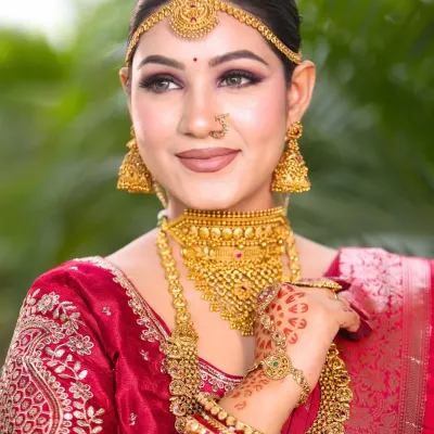 A beautiful candid shot of our South Indian bride. Her makeup features a soft smokey eye and a neutral lip, perfectly balancing the heavy gold jewelry and letting her natural beauty shine.