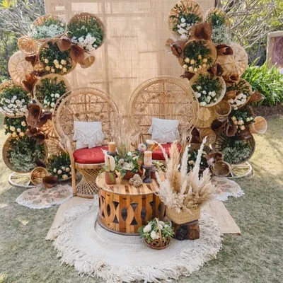 A perfect balance of wild and warm for a Mehendi. This seating features peacock-style cane chairs against a backdrop of woven baskets, pampas, and macrame, creating a free-spirited and inviting space.