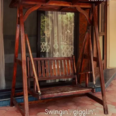 A wooden swing on the porch, perfect for quiet moments of reflection or planning your next big adventure.