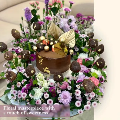 This floral masterpiece is one of my grandest creations. A rich chocolate cake sits at the center of an extravagant arrangement of fresh flowers and chocolate-covered strawberry pops, making for an unforgettable centerpiece.