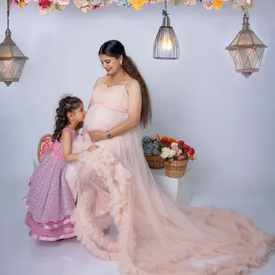 A truly precious moment between a mother and her daughter. The little girl whispers to the baby bump, creating a memory the family will cherish forever.