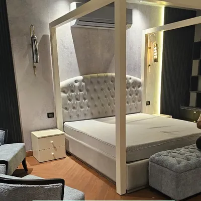 A poster bed is always a winner for adding a touch of drama. This modern four-poster bed features a classic button-tufted headboard and provides a grand focal point for the bedroom.