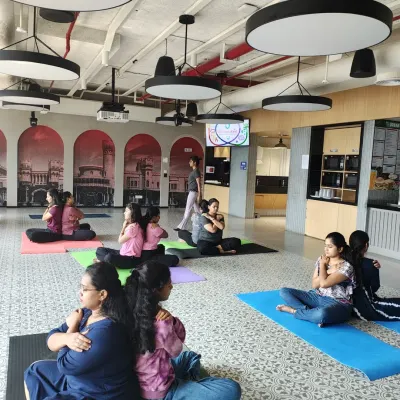 Partner yoga is a fantastic tool for building trust and communication. Here, employees at Johnson & Johnson support each other in a gentle back-to-back twist.