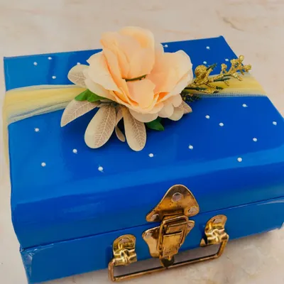 A special delivery for the bride-to-be. This beautiful blue trunk is decorated with a delicate flower and ready to be filled with goodies for her journey to the aisle.