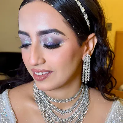 For this showstopper sangeet look, we went all out with dramatic, glittery eyes and rhinestones. The makeup is grand, glamorous, and designed to make a statement.