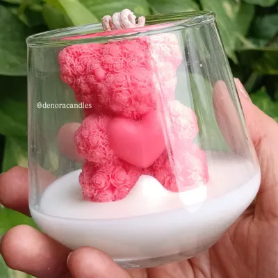 This pink teddy bear jar candle is simply adorable. It features a detailed rose-textured teddy bear holding a heart, making it a perfect gift for Valentine's Day, baby showers, or just to show someone you care.