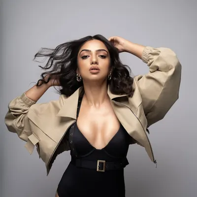 Birthday energy for Ahsaas Channa. This powerful look for her birthday photoshoot features a black belted bodysuit paired with a cropped khaki jacket and platform heels.
