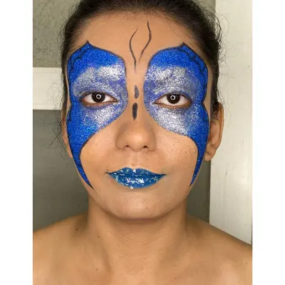 I created this bold, high-fashion butterfly look with vibrant blue and silver glitter, perfect for an editorial shoot or a model's portfolio that needs to stand out.