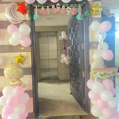 Welcome your baby girl home with a beautifully decorated entrance. We framed this doorway with pink and white balloon pillars, topped with star and moon foil balloons, and added a cute "Baby Girl" foil balloon to make the arrival extra special.