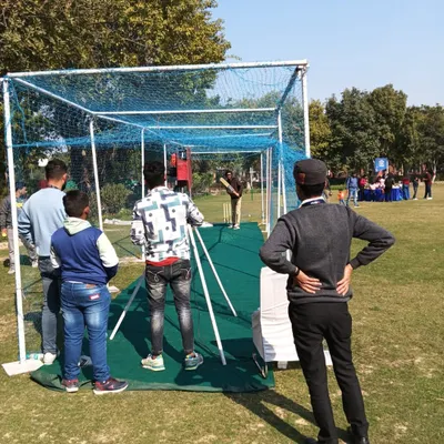 For cricket lovers, I offer a cricket bowling machine with a netted practice pitch. It's a fantastic and engaging activity for sports-themed parties and corporate family days.