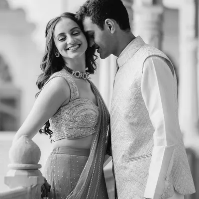 A classic black and white portrait of Saloni and Kanav from their palace shoot. The soft lighting and their gentle expressions create a feeling of timeless romance.