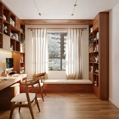 This beautiful home office is built around a window, maximizing natural light. We designed custom floor-to-ceiling wooden bookshelves and a window seat with built-in storage, creating a warm, academic, and highly functional workspace.