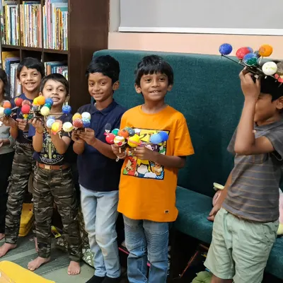 Our little astronomers proudly display the solar system models they built and painted. This project is a great way to learn about the planets.