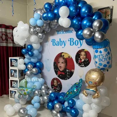 For this "Welcome Baby Boy" celebration, I designed a custom backdrop featuring the baby's own photos. The blue and silver balloon arch and themed foil balloons make it a truly personal and heartwarming setup.