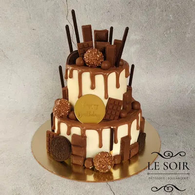 A chocolate lover's dream. This 1.5 kg two-tier Milk Chocolate Truffle cake is loaded with various chocolates like Ferrero Rocher, KitKat, and Oreos, and finished with a chocolate drip.