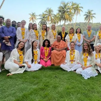The opening ceremony for our 200-hour YTTC in Goa. The entire group, a mix of students and teachers, comes together on the lawn, adorned with marigold garlands, to begin their shared journey.