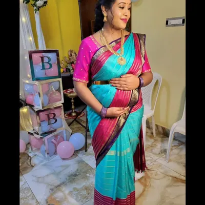 For this mom-to-be's baby shower, I styled a vibrant Mysore silk saree to be both beautiful and comfortable. The drape is adjusted to gracefully accommodate the baby bump, ensuring she feels secure and celebrated.