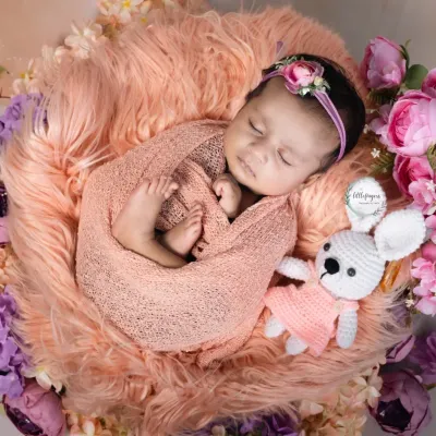 Curled up and dreaming, surrounded by soft textures and flowers. My newborn sessions are designed to be calm and peaceful, focusing on the delicate beauty of your sleeping baby.
