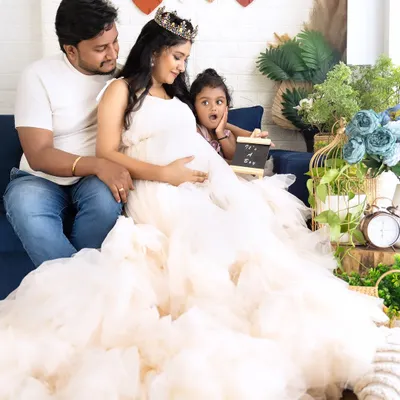 A candid and adorable family moment on the couch, with the older sister making a surprised face. It's these real moments that make the best memories.
