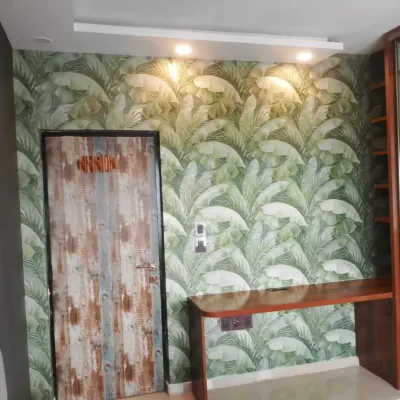 A vibrant banana leaf wallpaper that makes a bold statement in this study nook. The lush green pattern creates a fresh and energetic atmosphere.