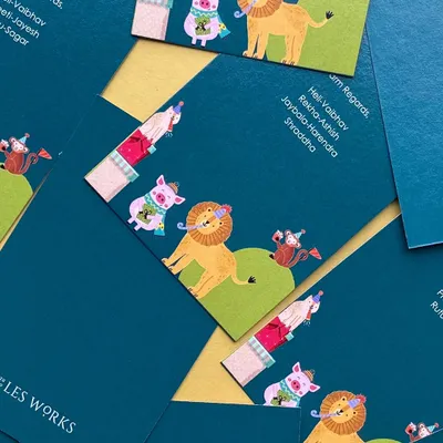 A close-up of some fun and colorful gift tags for a baby announcement. The design features a party of cute, illustrated jungle animals, perfect for celebrating a new arrival.