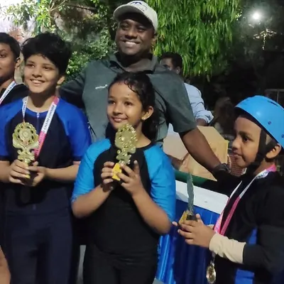 Celebrating our winners. These students are proudly showing off the trophies and medals they earned through their hard work and competitive spirit.