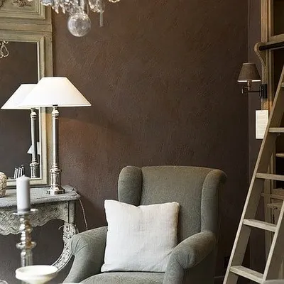 A subtle, brushed texture on a dark brown wall adds warmth and sophistication to this classic living room. This finish provides an elegant alternative to a flat paint surface, enhancing the room's cozy feel.