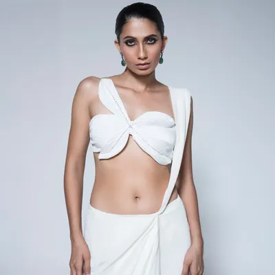 This is the hero shot of a modern draped saree I styled. The focus is on the innovative knot detail and the clean, sculptural lines of the fabric, creating a look of pure, minimalist sophistication.