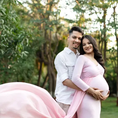 A perfect day for an outdoor shoot! This couple looks so happy together, surrounded by lush greenery. The way the pink fabric of her gown flows in the breeze adds a beautiful, dynamic element to the photo.