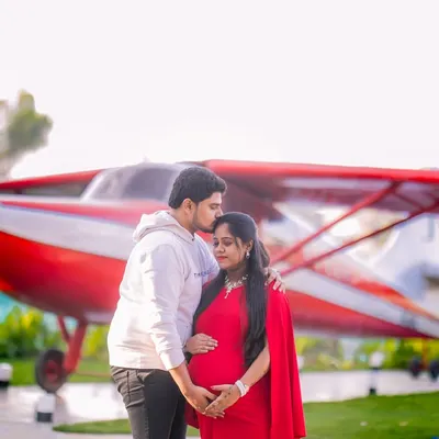 A tender maternity moment in front of our standout red airplane prop. It's a unique backdrop that adds a touch of adventure to your photoshoot.