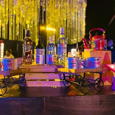 My Bollywood themed bar setup in full swing. I use props like miniature handcarts and custom-printed cans with movie dialogues to display liquor, creating a fun and immersive experience for all the film buffs.