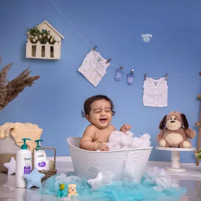 Bath time giggles are the best! This little one is having a wonderful time splashing around in a tub full of bubbles.